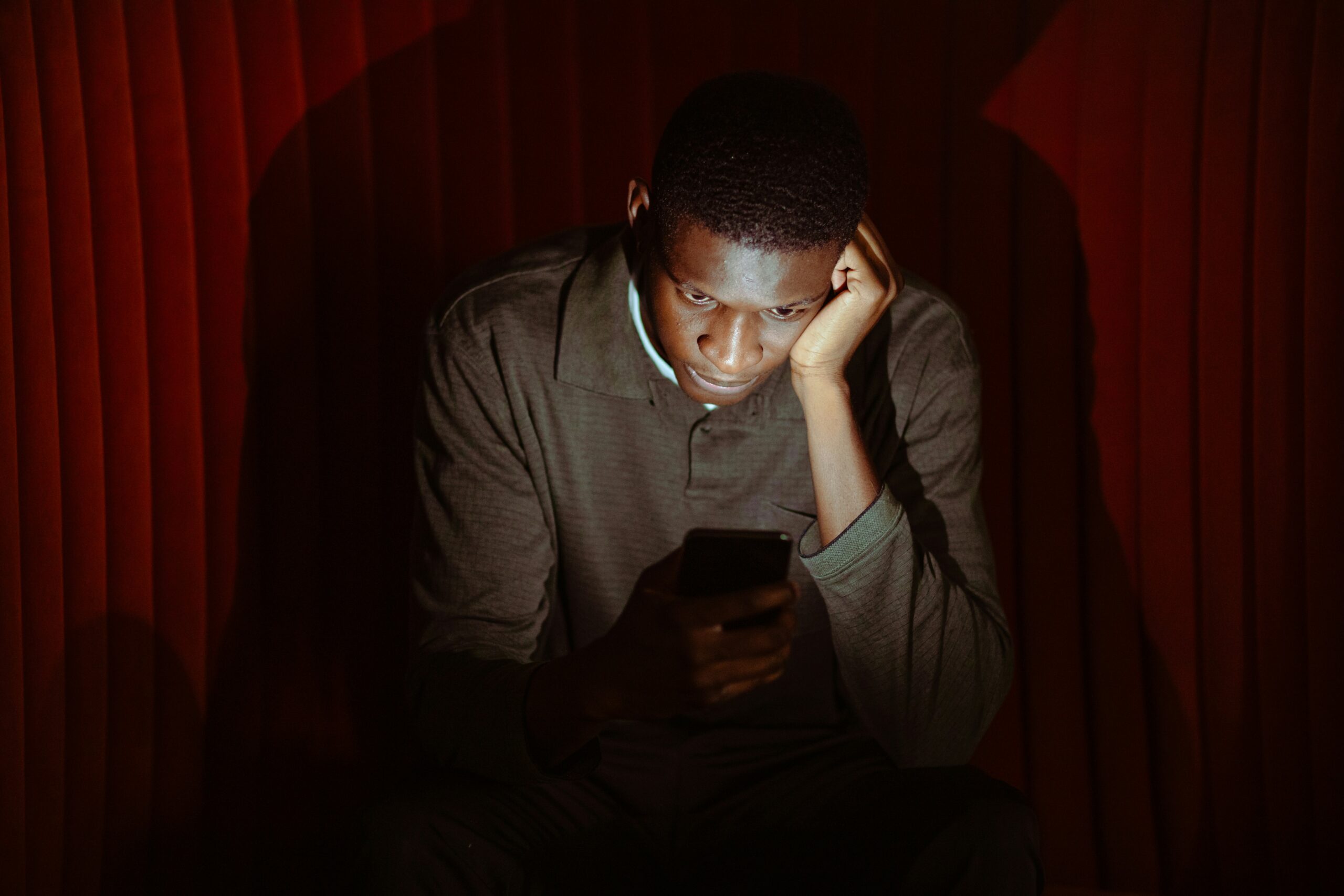 man reading spam label on phone call sad